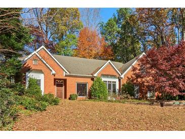 Brick house with a large front yard and mature trees at 230 Wessex Ct, Atlanta, GA 30328