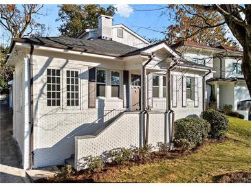 Charming renovated brick home with a welcoming front porch and landscaped lawn at 2044 Fairhaven Cir, Atlanta, GA 30305