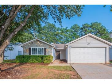 Gray house with stone accents and a two-car garage at 150 Lake Ter, Mcdonough, GA 30253