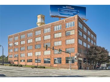 Brick building with many windows and a billboard in the background at 426 Marietta Nw St # 410, Atlanta, GA 30313