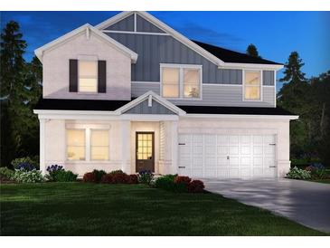 Two-story house with gray and white siding, a two-car garage, and landscaping at 316 Tallulah Ln, Grayson, GA 30017