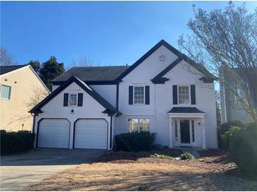 Two-story house with white siding, black accents, and a two-car garage at 2630 Kingsbrooke Ln, Duluth, GA 30097