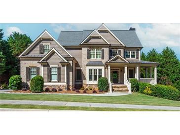 Two story house with gray siding, brick accents, and a large front porch at 1191 Hillside Green Way, Powder Springs, GA 30127