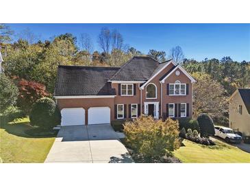 Brick house with two-car garage, landscaping and driveway at 4560 Candytuft Nw Way, Acworth, GA 30102