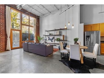 Open living area with high ceilings, exposed beams, and modern furniture at 174 Chester Se Ave # 132, Atlanta, GA 30316