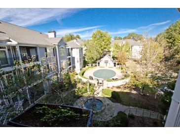 Aerial view of apartment community courtyard with fountain and landscaping at 4100 Paces Walk # 1301, Atlanta, GA 30339