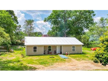 Ranch style home with metal roof and landscaped yard at 101 Old Tennessee Rd Ne, Cartersville, GA 30121