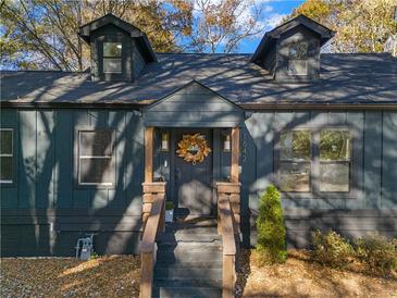 Stylish dark-grey house with wood accents, inviting front porch, and landscaping at 1642 Van Epps Se St, Atlanta, GA 30316