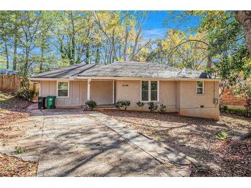 Brick ranch house with a spacious front yard and driveway at 2194 Tilson Cir, Decatur, GA 30032