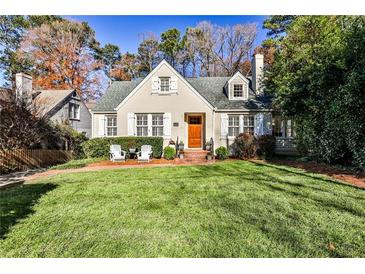 Charming brick home with a spacious lawn and mature trees at 647 Longwood Nw Dr, Atlanta, GA 30305