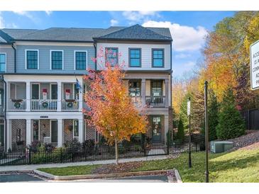 Two story townhome with front porch and landscaped yard at 217 Bluestone Dr, Woodstock, GA 30188