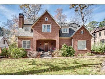 Brick home with a classic design, featuring a large front yard and mature trees at 1376 Oak Grove Dr, Decatur, GA 30033