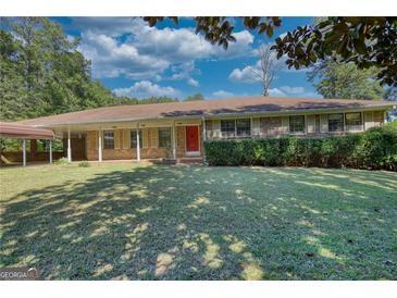 Ranch style home with carport and spacious lawn at 11790 Brown Bridge Rd, Covington, GA 30016