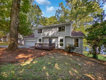 Two-story house with gray siding, a deck, and attached garage at 9001 Mandarin Dr, Jonesboro, GA 30236