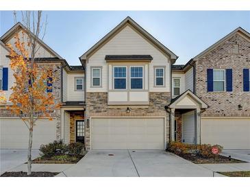 Modern three-story townhome with neutral colors and attached two-car garage at 1124 Lossie Ln, Grayson, GA 30017
