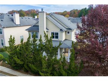 Two-story house with a front porch, partially obscured by trees and landscaping at 4701 Highpoint Ln, Atlanta, GA 30349