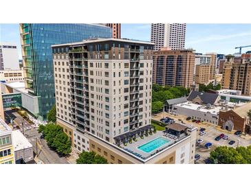 High-rise building with rooftop pool; city views at 565 Peachtree Ne St # 1209, Atlanta, GA 30308