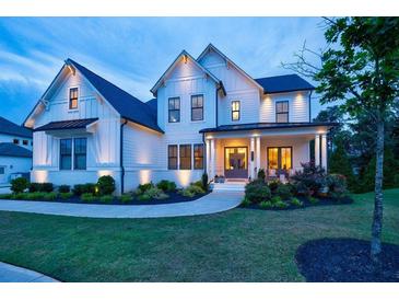 Stunning two-story farmhouse with a charming front porch and landscaping at 4992 Concert Ln, Marietta, GA 30066