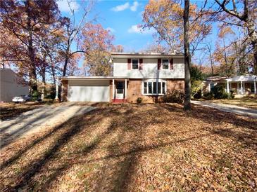 Brick ranch home with attached garage and mature trees at 492 Camelot Pkwy, Jonesboro, GA 30236