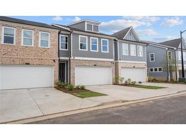 Modern townhouses with attached garages and landscaped yards at 1060 Rose Dr, Marietta, GA 30060