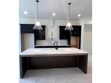 Modern kitchen with dark cabinetry, quartz countertops, and large island at 2257 Addington Way, Atlanta, GA 30319