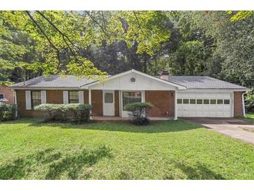 Brick ranch house with attached garage and a spacious lawn at 2616 Landington Nw Way, Duluth, GA 30096
