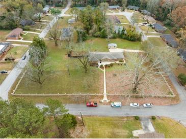 Aerial view showing single-story house with large yard and ample parking at 3645 Aldea Dr, Decatur, GA 30032