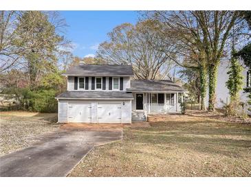 Charming ranch home with a two-car garage and well-manicured lawn at 676 Tarkington S Rd, Stone Mountain, GA 30088