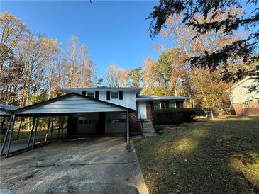 Brick ranch home with carport and landscaped yard at 5423 Pine Valley Dr, Union City, GA 30291