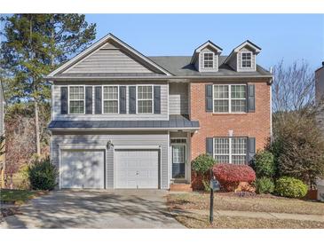 Two-story brick and gray siding house with a two-car garage and manicured lawn at 260 Wildcat Lake Dr, Lawrenceville, GA 30043