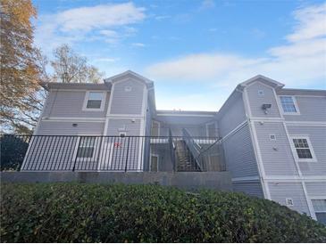 Exterior view of a two-story building with gray siding and a staircase at 4279 Orchard Grv, Stone Mountain, GA 30083