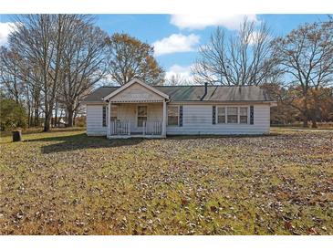 Single-story home with covered front porch and large front yard at 2948 Lenora Rd, Snellville, GA 30039