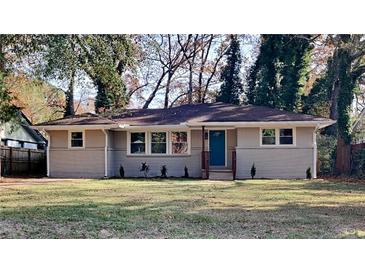 Newly renovated ranch home with landscaped yard and a teal front door at 1864 Pinedale Pl, Decatur, GA 30032