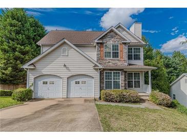Two-story house with stone accents and a two-car garage at 5439 Village Rdg, Fairburn, GA 30213