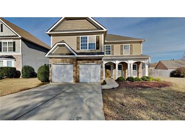 Two-story house with stone accents and a three-car garage at 50 Stallion Way, Hiram, GA 30141