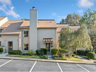 Inviting exterior of a two-story townhome with landscaping and parking at 3623 Stonewall Se Ct, Atlanta, GA 30339