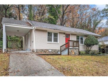 Brick ranch home with covered carport and landscaped yard at 1883 Meadow Ln, Decatur, GA 30032