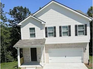 Two-story house with white siding, black shutters, and a two-car garage at 558 Fairview Oak Pl, Dallas, GA 30157