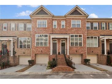 Charming brick townhome with two-car garage and inviting front entrance at 1690 Mosaic Way, Smyrna, GA 30080