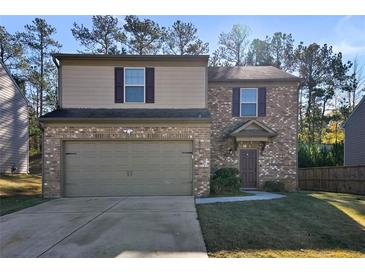 Two-story brick house with a two-car garage and a well-manicured lawn at 2327 Clapton Ct, Jonesboro, GA 30236