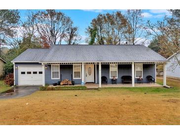 Ranch style home with covered porch and attached garage at 733 Brandlwood Nw Way, Lilburn, GA 30047