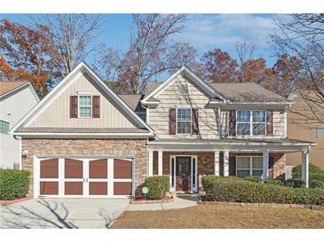 Two-story house with stone accents and a brown-trimmed garage at 3547 Valley Bluff Ln, Snellville, GA 30039