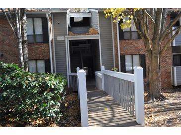 Brick building exterior with walkway and landscaping at 207 Warm Springs Cir, Roswell, GA 30075