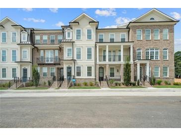 Three-story townhouses with brick and siding, front porches, and landscaping at 2541 High Brow St # 40, Duluth, GA 30096