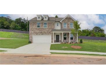 Two story brick home with attached garage and landscaped lawn at 307 Collier Mill Road, Lawrenceville, GA 30045