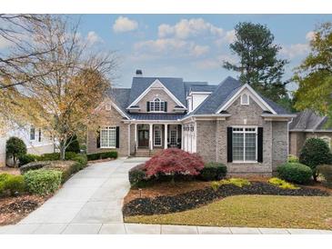 Brick home with landscaping, driveway, and a three-car garage at 6191 Talmadge Run, Acworth, GA 30101