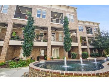 Brick townhome community with a central fountain at 333 Brownstones Ne Cir, Atlanta, GA 30312