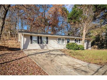 Ranch style home with a long driveway and mature trees at 195 Pinehurst Dr, Stockbridge, GA 30281
