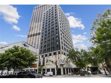 High rise building in the city with surrounding streets and cars at 20 Marietta Nw St # 4D, Atlanta, GA 30303