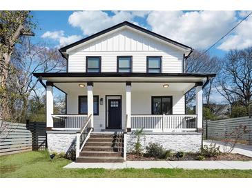 Charming two-story home features a white exterior, black accents, and a welcoming front porch at 912 Ira Sw St, Atlanta, GA 30310